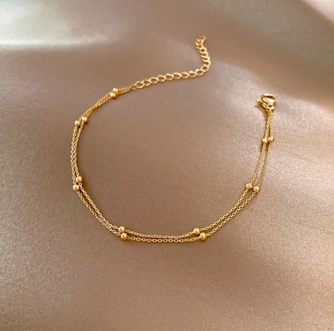 Hermosa pulsera dobledorada de 18 quilates con perlas