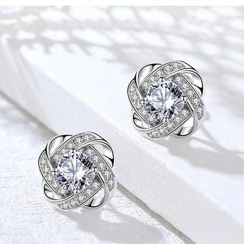 Pendientes de cruz en espiral con flores