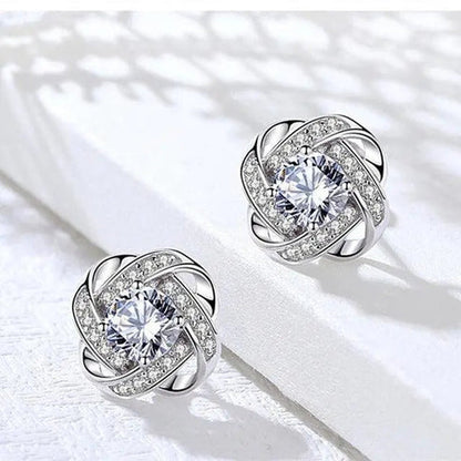Pendientes de cruz en espiral con flores